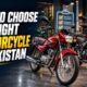 Rider comparing bikes in a showroom to choose a motorcycle in Pakistan