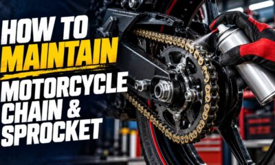 Mechanic oiling a motorcycle chain and sprocket in a Pakistan workshop
